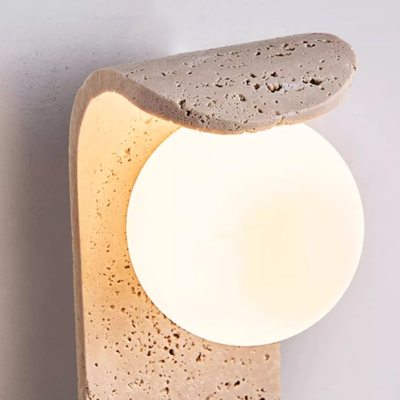 Irregularly shaped yellow travertine wall lamp